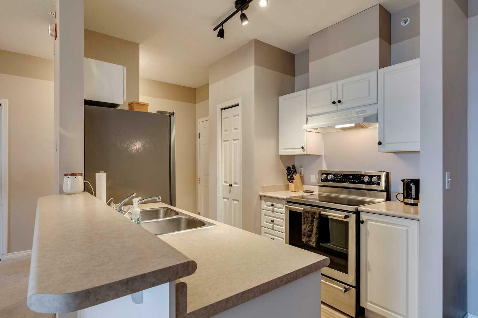 Property Photo:  16 Poplar Avenue 403  AB T1S 1Z5 