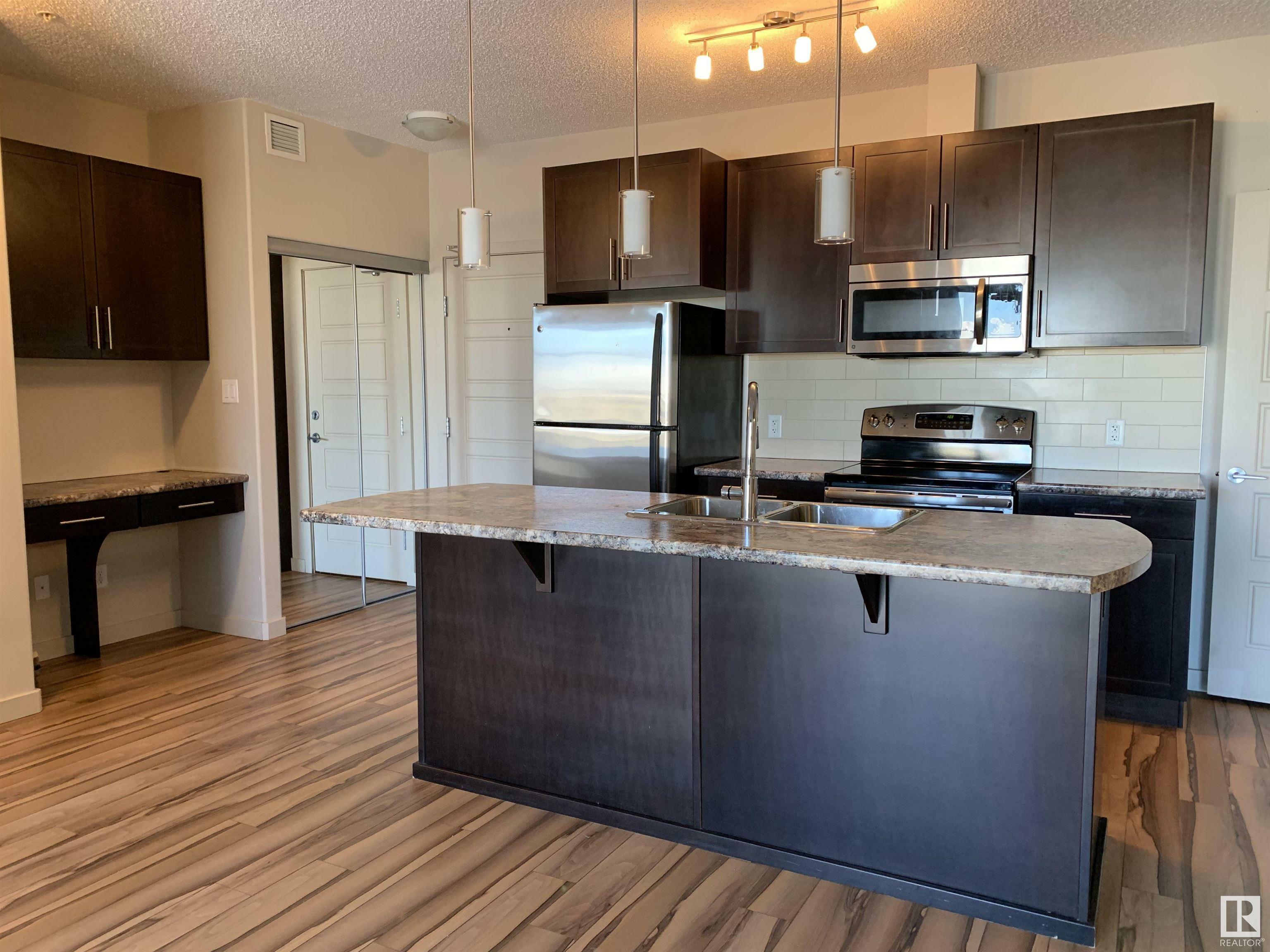 Property Photo: 1144 Adamson Drive SW 317 AB T6W 2X7