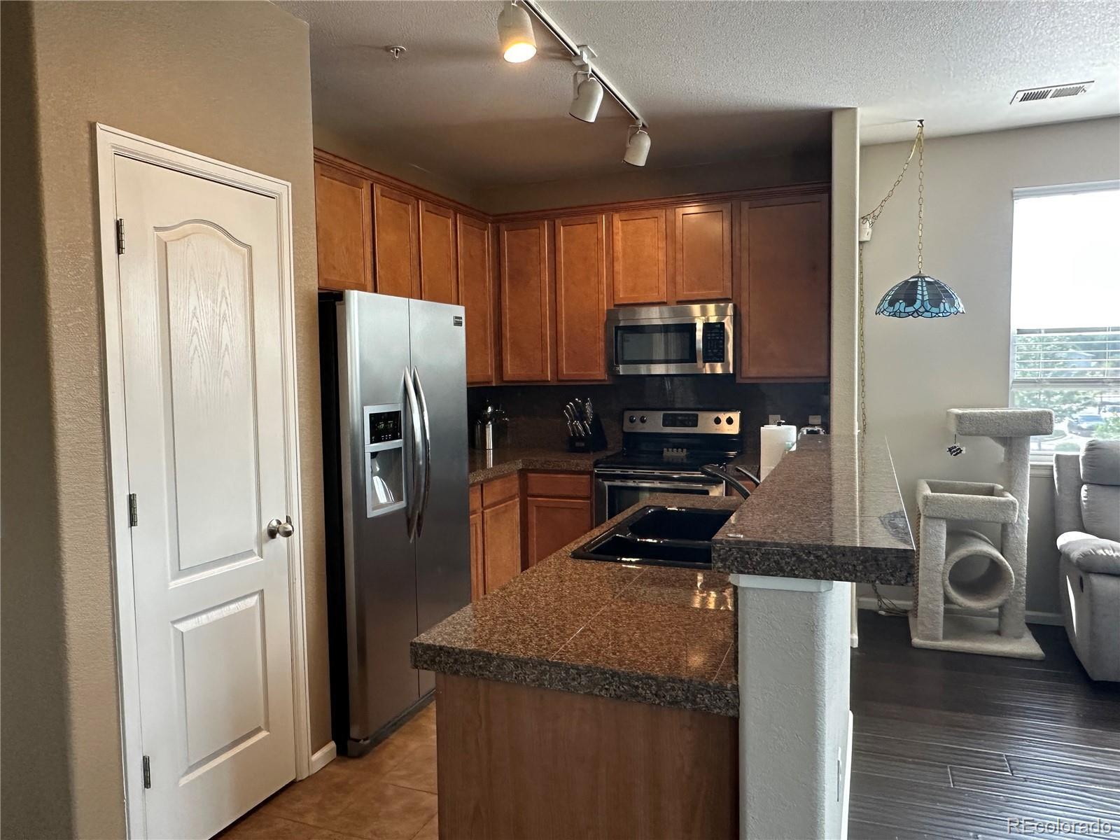 Property Photo: 7140 Simms Street 202 CO 80004
