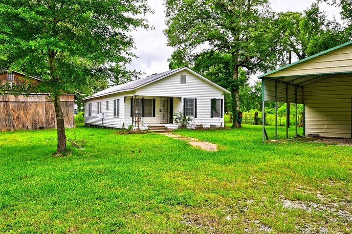 Property Photo: 1083 County Road 3141 TX 77327