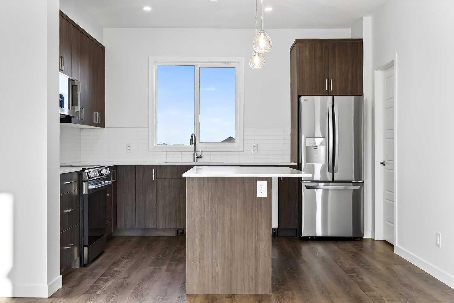 Property Photo: 40 Creekside Way SW 303 AB T2X 6E2