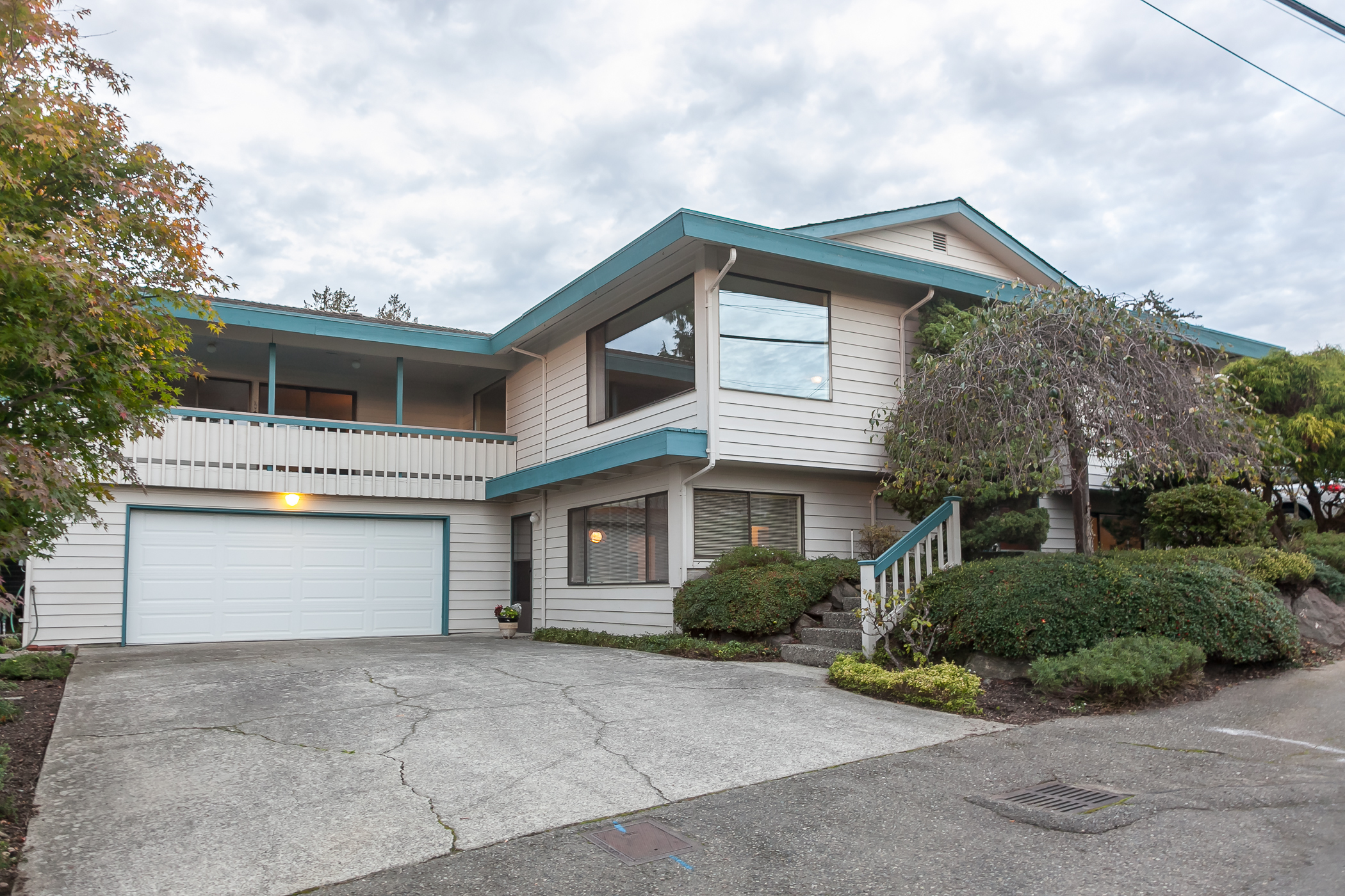 Property Photo: Interior: living and dining + exterior: front 2110 NW 199th St  WA 98177 